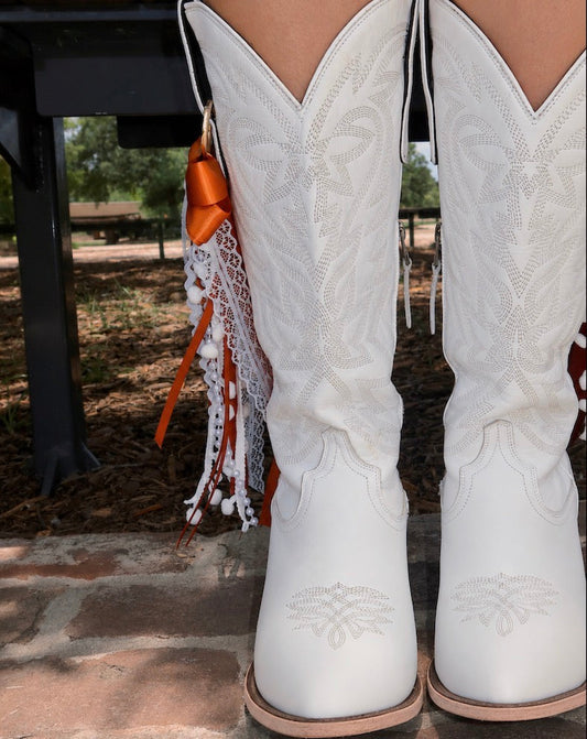 Cowboy boots with boot bows styled for game day western fashion