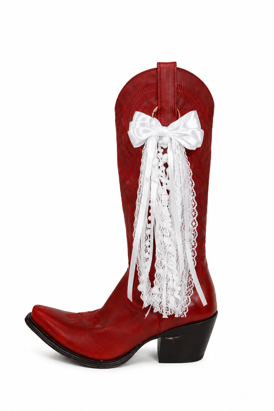 Red cowboy boot with a white lace bow on a white background